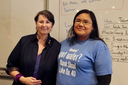 Senator and Course Director Marilou McPhedran stands with 2018 student. The student shirt states " Winnipeg! got water? Thank Shoal Lake No. 40."