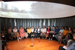 Students watch video in Indigenous Perspectives gallery