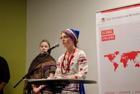 2018 Student stands at podium in traditional Ukrainian dress for their group presentation.